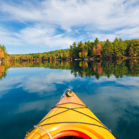 POV from a kayaker on a lake in the fall